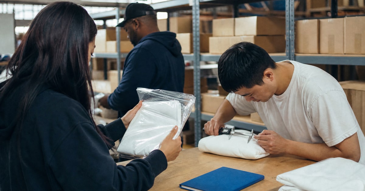 Flapen cover for Build vs buy for your Amazon channel: the complete guide: a seller holding their own sample while a Flapen operator checks a matching one