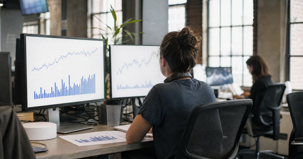 Flapen cover for End to end Amazon catalog optimization services: a Flapen operator between two monitors of charts with a printed report