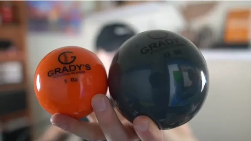 5 oz and 32 oz Grady's balls held up to the camera
