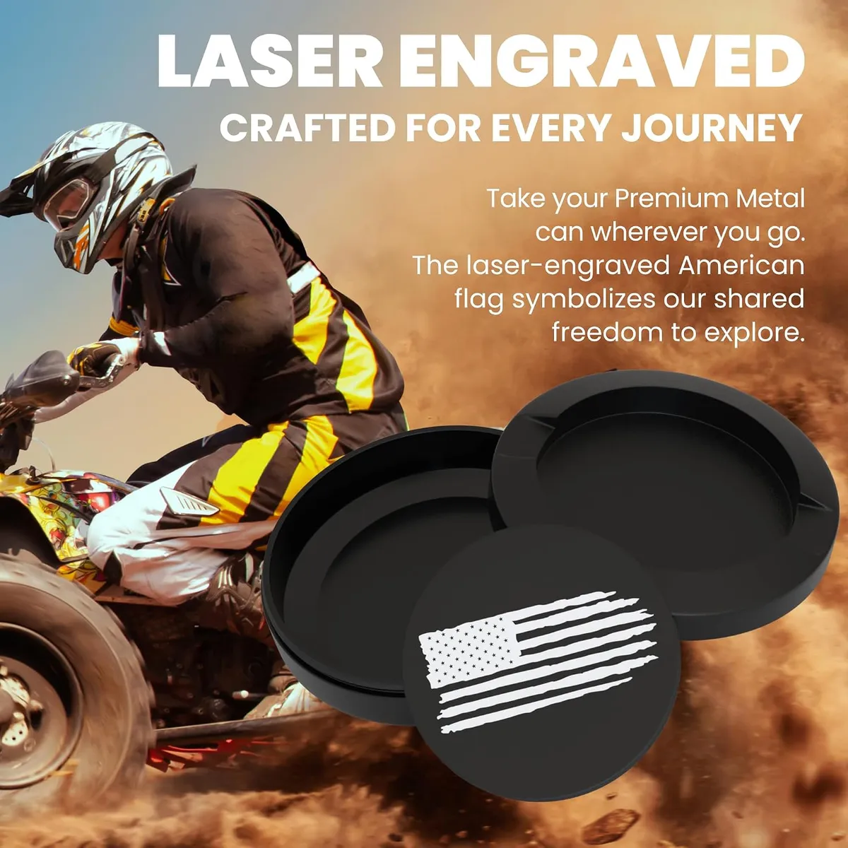 Two open black metal cans and an engraved lid in the foreground while a quad-bike rider kicks up dust behind them