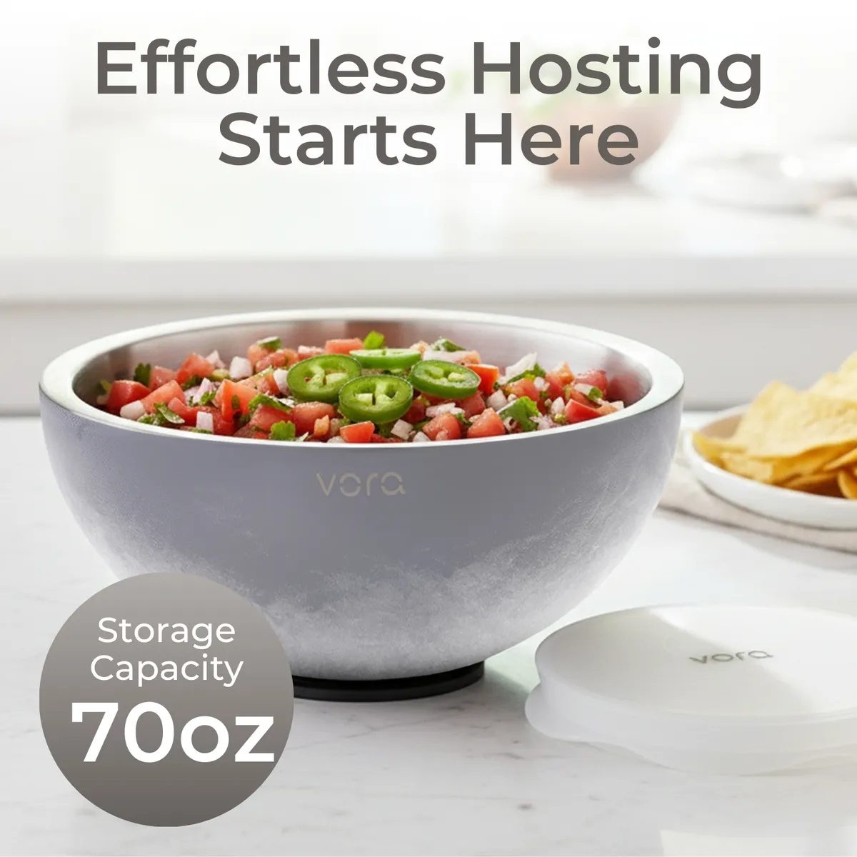 Frosted grey 70oz Vora bowl of pico de gallo on a marble kitchen counter, lid and plate of tortilla chips nearby
